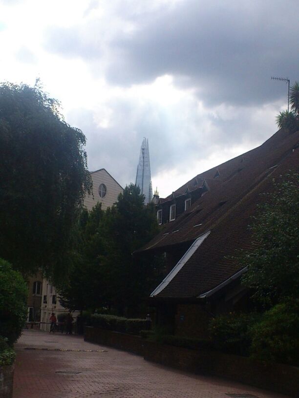 VIEW OF BUILDINGS AGAINST CLOUDY SKY