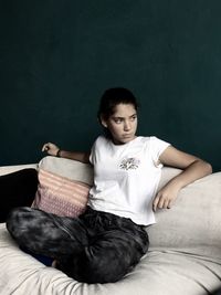 Girl sitting on sofa at home