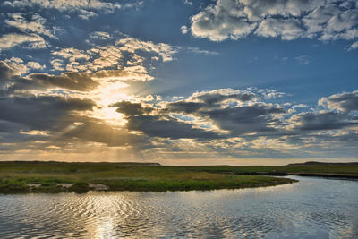 Scenic view of lake against sky during sunset