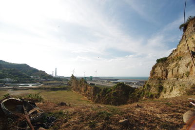 Scenic view of sea and mountains against sky