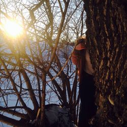 Woman standing in snow covered tree