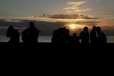 Silhouette of people at sunset