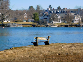 Scenic view of lake by buildings against sky