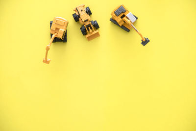 High angle view of toys toy against yellow background