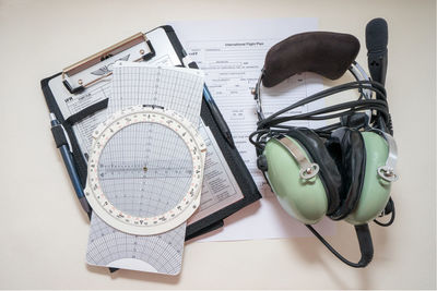 High angle view of headphones with papers on table