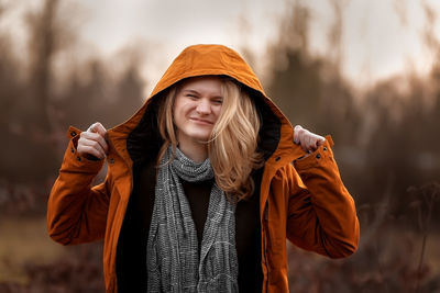 Portrait of young woman standing outdoors