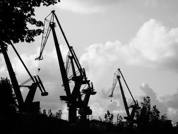 Cranes against sky