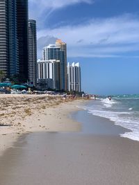 Buildings by sea against sky in city