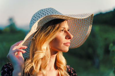 Portrait of young woman looking away outdoors