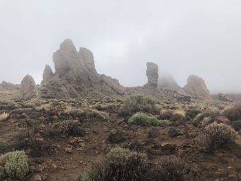 Rock formations on landscape against sky