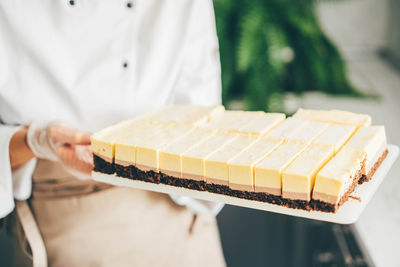 Chef showing desserts on plate.