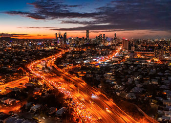 High angle view of illuminated city buildings at night