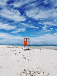 Lifeguard hut on beach against sky