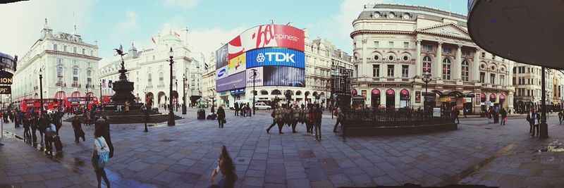 Panoramic view of people in city against sky