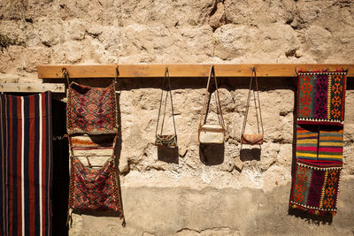 Bags drying on clothesline on wall