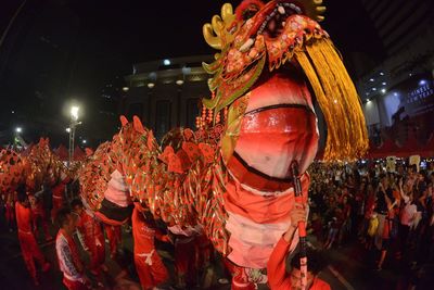 People carrying chinese dragon during event in city