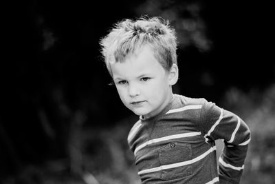 Portrait of cute boy standing outdoors