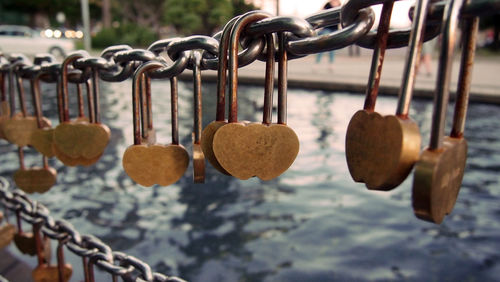 Close-up of padlocks hanging on railing