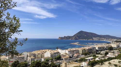 High angle view of townscape by sea against sky