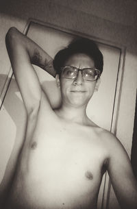 Portrait of handsome young man wearing eyeglasses at home