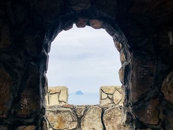 View of old ruins through cave