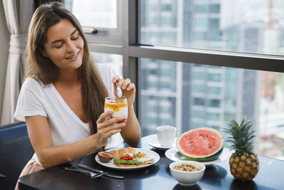 Portrait of young woman having food