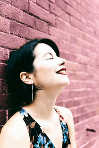 Portrait of woman against wall