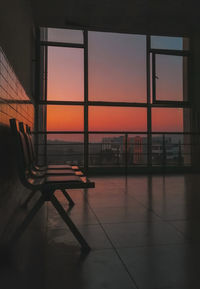 Scenic view of orange sky seen through glass window