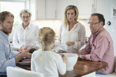 Family preparing food together in kitchen