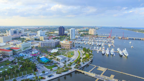 High angle view of cityscape by river against sky