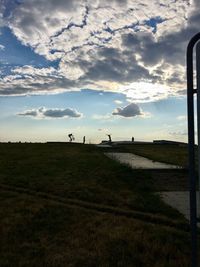 Scenic view of silhouette field against sky during sunset