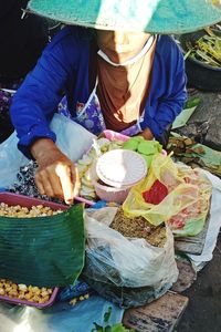 Low section of person preparing food at market stall