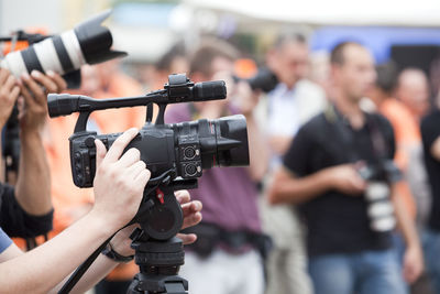 Midsection of cameraman photographing outdoors