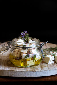 Close-up of ice cream in glass on table against black background