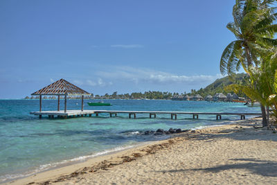 Built structure on beach against blue sky