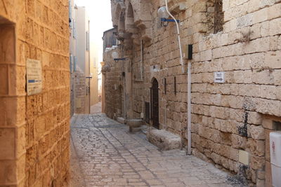 Narrow alley amidst buildings in city