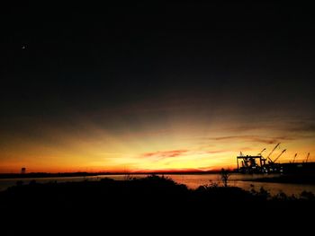 Silhouette of cranes at sunset