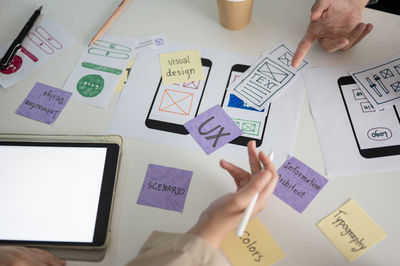 Cropped hand of business colleagues working in office