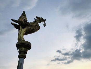 Low angle view of statue against cloudy sky