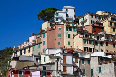 Low angle view of buildings against clear blue sky