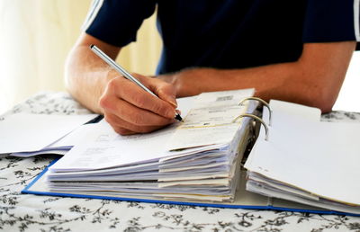 Midsection of man working at table