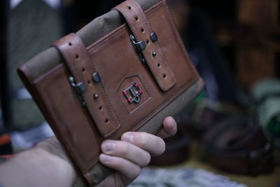 Cropped hand of woman holding purse