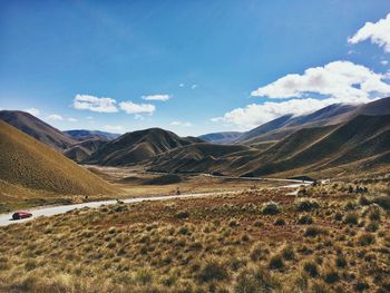 Scenic view of mountains against cloudy sky