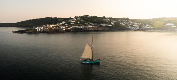 Sailboat sailing on sea against sky