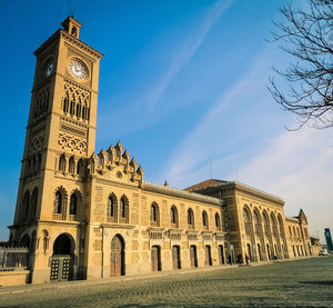 Low angle view of clock tower against sky in city