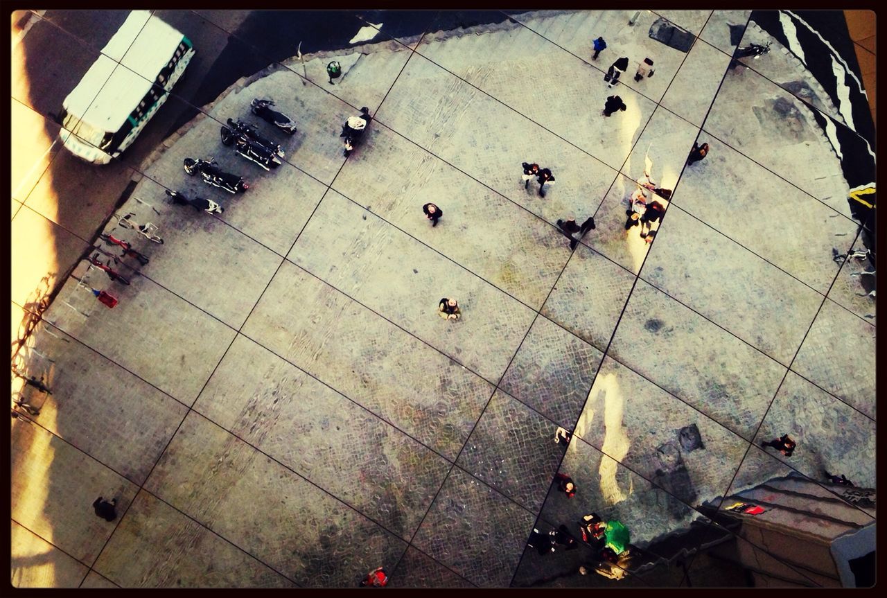 transfer print, auto post production filter, high angle view, transportation, built structure, architecture, street, mode of transport, travel, men, large group of people, land vehicle, day, elevated view, shadow, outdoors, building exterior, sunlight, city