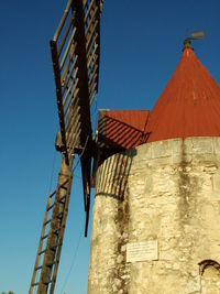 Low angle view of built structure against clear blue sky