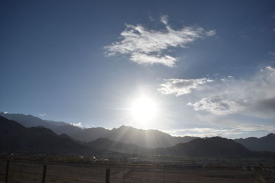 Scenic view of mountains against bright sun