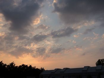 Low angle view of building against cloudy sky