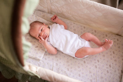 High angle view of baby sleeping on bed at home